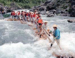 Tourists enjoy rafting on river